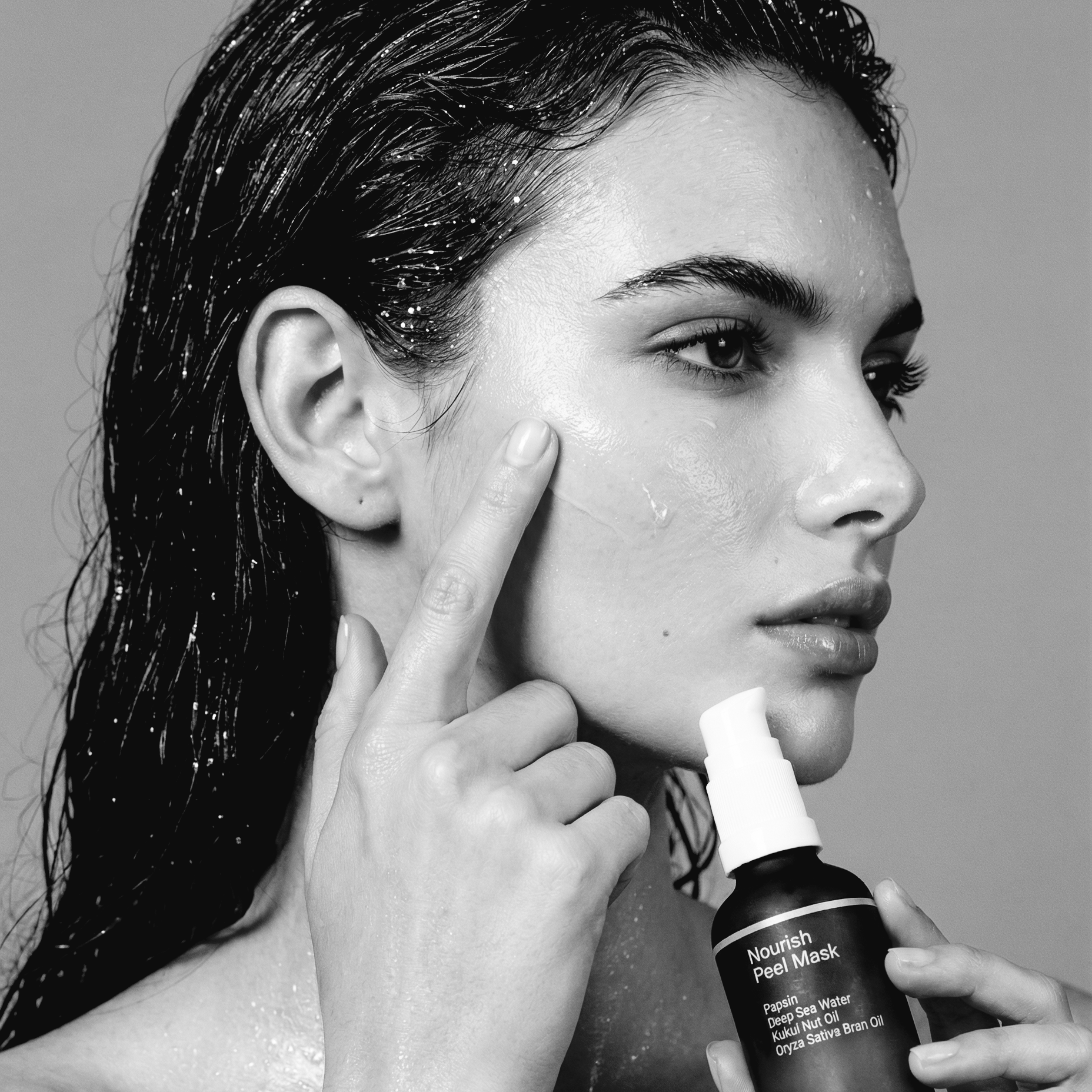 Use_the_exact_same_woman_from_the_picture._Show_her_from_the_side._She_uses_one_finger_to_apply_serum_on_her_face.png